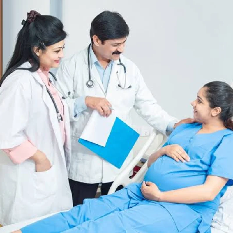 Smiling expectant mother in a saree